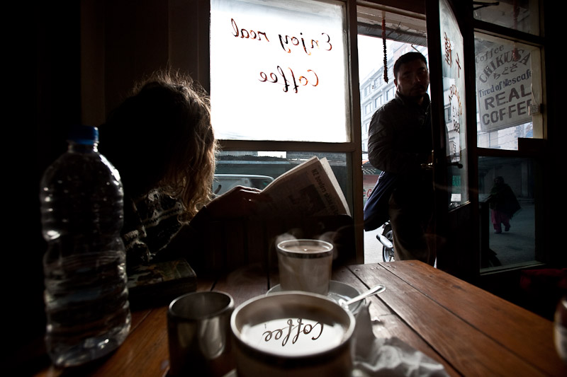 Guy reading a paper and sipping some real joe at Kathmandu's Coffee Chikusa